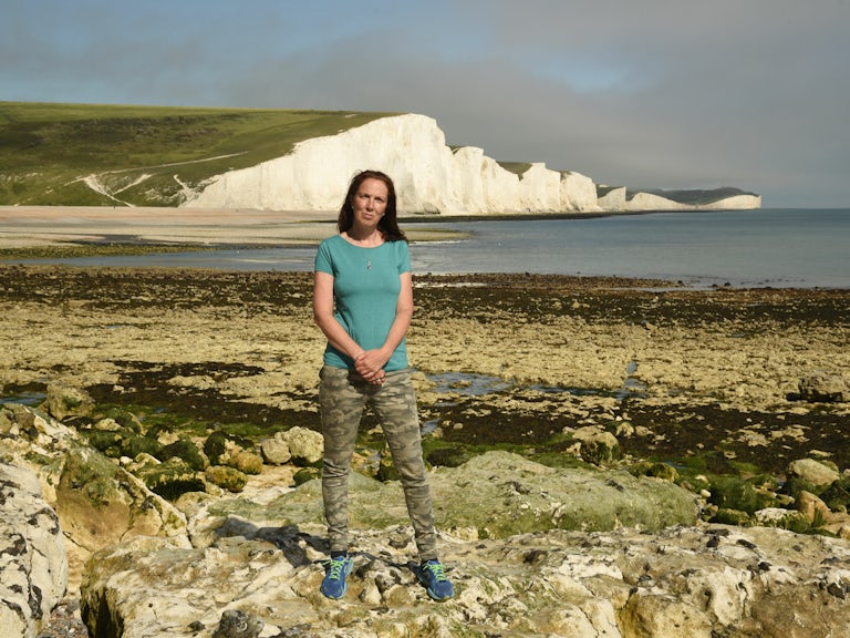 Henri Brocklebank, Director of Conservation, Sussex Wildlife Trust, standing on a beach in Sussex